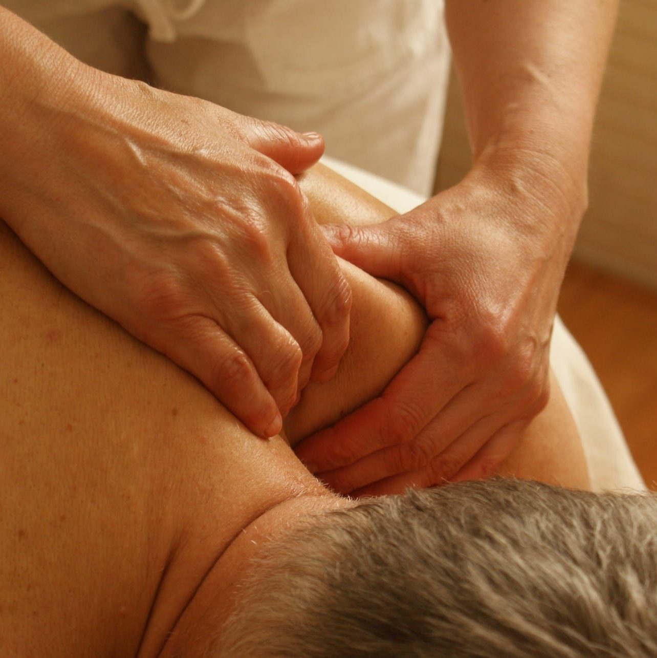 Person Massaging Man's Shoulder